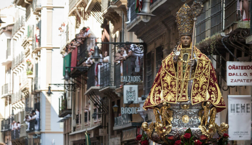 Religious procession in a narrow city street.